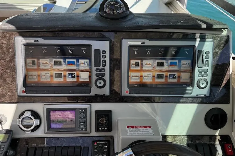 Slide: The Image of Control panel of a 2010 Sea Ray 470 Sundancer yacht with dual navigation screens. - 17
