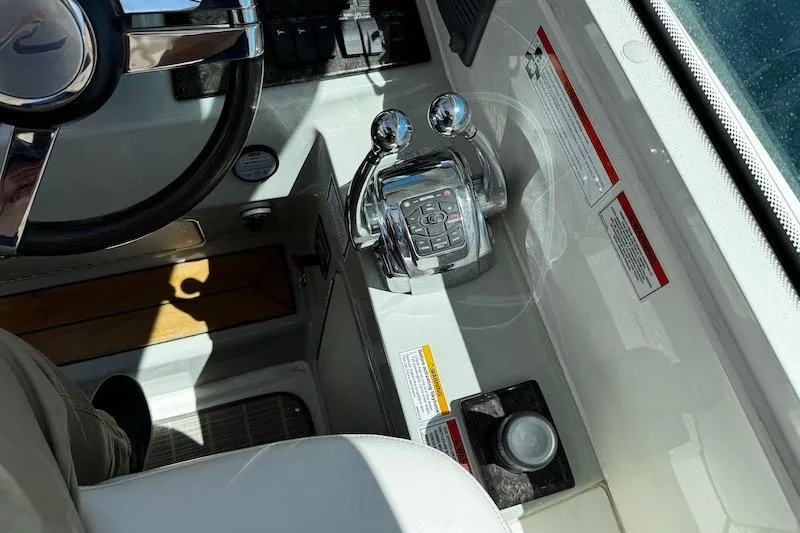 Slide: The Image of Cockpit controls of a 2010 Sea Ray 470 Sundancer yacht, featuring dual throttle levers. - 18