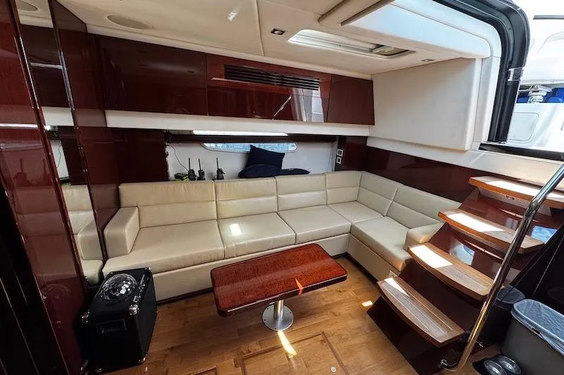 Slide: The Image of Luxurious interior of 2010 Sea Ray 470 Sundancer yacht with leather seating and wooden accents. - 24