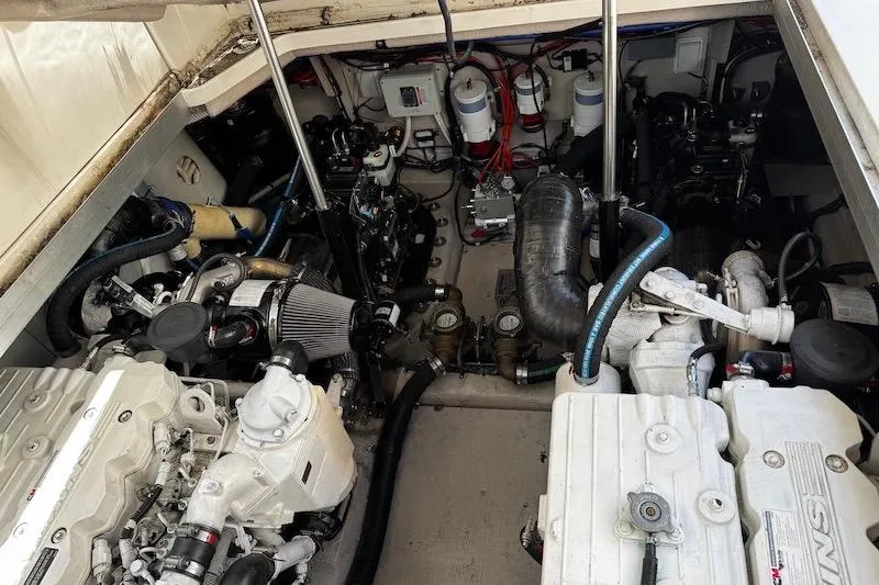 Slide: The Image of Engine room of a 2010 Sea Ray 470 Sundancer, showcasing dual engines and mechanical components. - 21