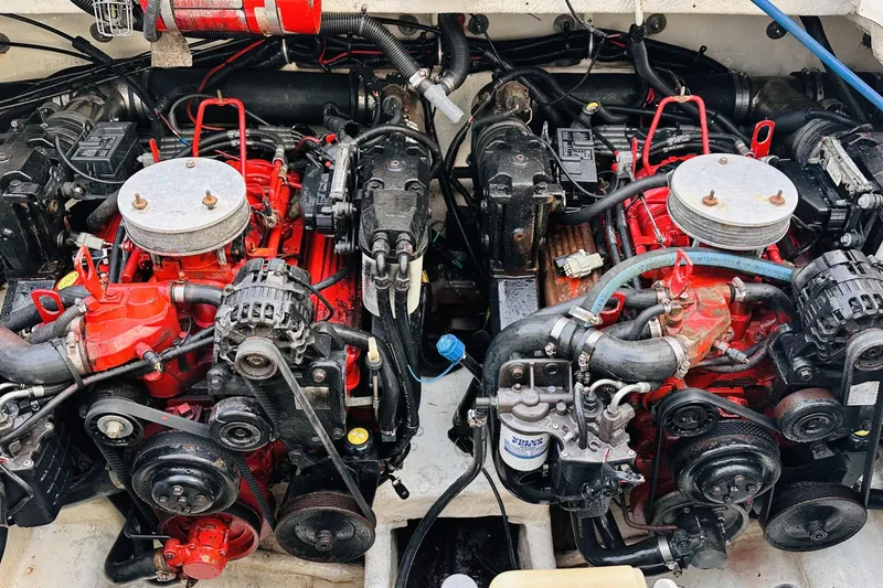 Slide: The Image of Engine compartment of a 2006 Monterey 298SC Super Sport boat, featuring dual red engines. - 13