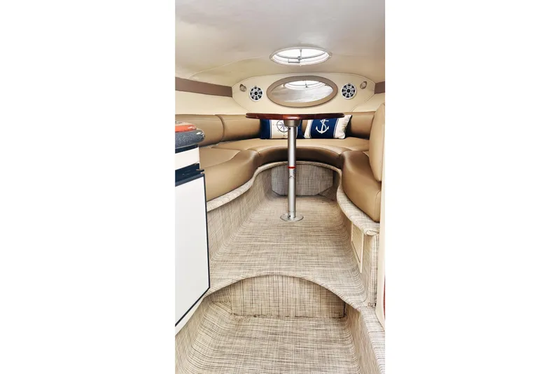 Slide: The Image of Interior of 2006 Monterey 298SC Super Sport boat with beige seating and nautical decor. - 10