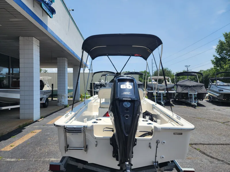 Slide: The Image of A 2023 Boston Whaler 150 Montauk on a trailer outside a building. - 15
