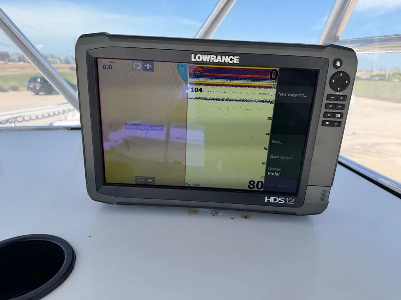 Slide: The Image of A Lowrance HDS12 fishfinder on a boat, displaying depth information. - 21