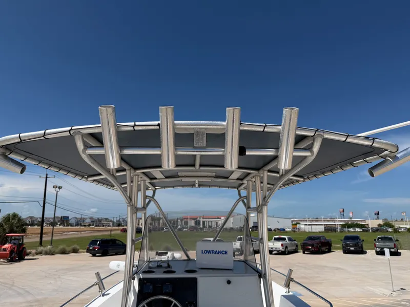 Slide: The Image of A 2002 PRO SPORT PRO KAT 2200 boat with a sturdy T-top and fishing rod holders. - 25