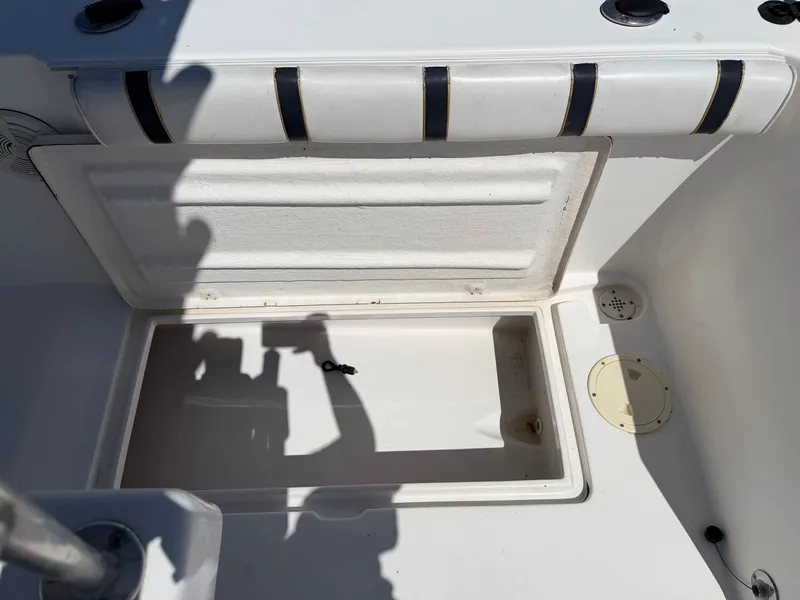 Slide: The Image of An open storage compartment on a boat with a padded edge. - 29