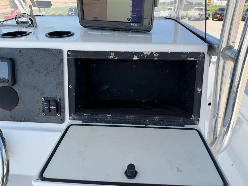 Slide: The Image of The image shows the dashboard of a 2002 PRO SPORT PRO KAT 2200 with an empty compartment. - 22