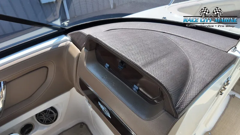 Slide: The Image of The image shows the dashboard of a 2015 Chaparral 277 SSX with an open storage compartment. - 47
