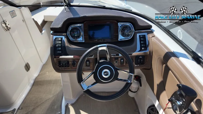 Slide: The Image of The image shows the cockpit of a 2015 Chaparral 277 SSX with a modern dashboard and sleek steering wheel. - 49