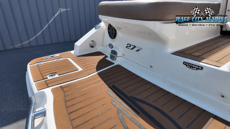 Slide: The Image of The image shows the stern of a 2015 Chaparral 277 SSX boat with teak-style decking. - 11