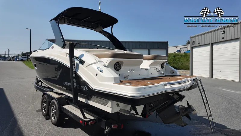 Slide: The Image of A 2015 Chaparral 277 SSX boat on a trailer in front of a building. - 7