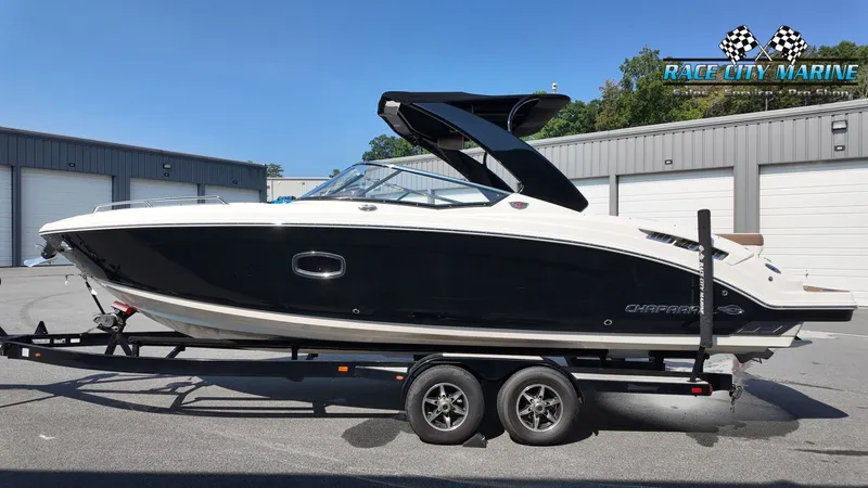 Slide: The Image of A 2015 Chaparral 277 SSX boat on a trailer in front of a building. - 2