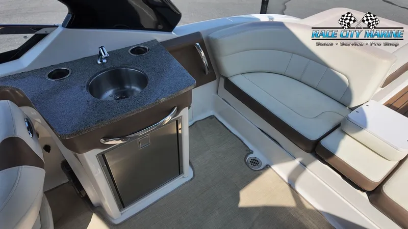 Slide: The Image of The image shows the cockpit of a 2015 Chaparral 277 SSX with a small sink and seating area. - 44