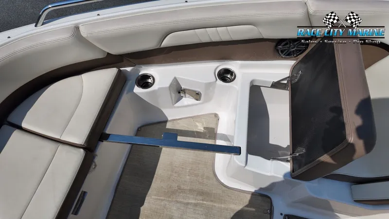Slide: The Image of The image shows the seating area of a 2015 Chaparral 277 SSX boat with beige upholstery. - 30