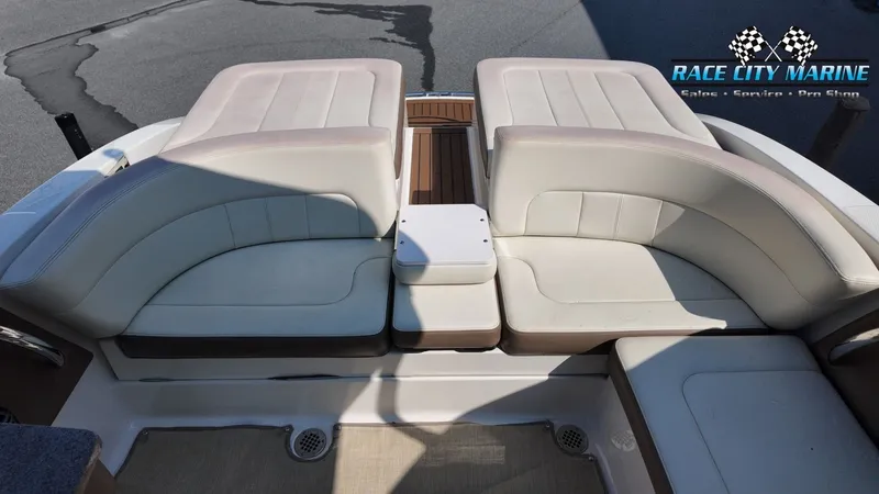 Slide: The Image of The image shows the stern of a Chaparral 277 SSX boat with beige upholstered seats. - 17