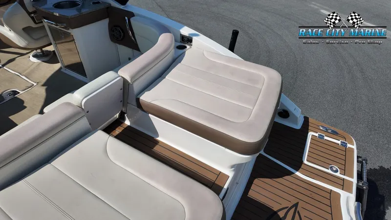 Slide: The Image of The image shows the stern of a 2015 Chaparral 277 SSX boat with beige upholstery. - 12
