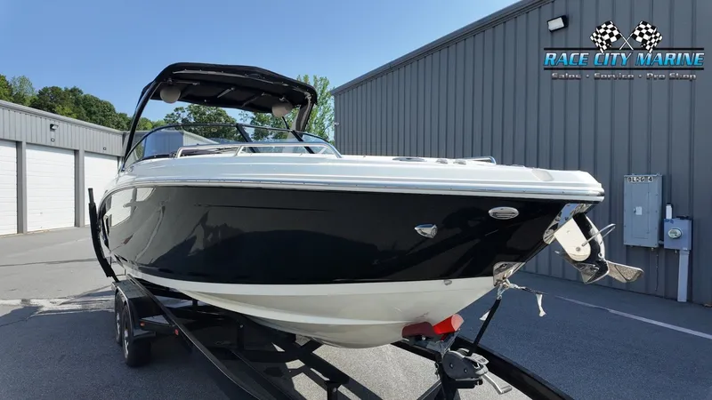 Slide: The Image of A 2015 Chaparral 277 SSX boat on a trailer in front of a building. - 5