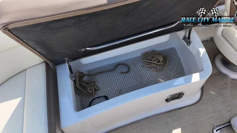 Slide: The Image of An open storage compartment on a boat with ropes and a hook inside. - 27