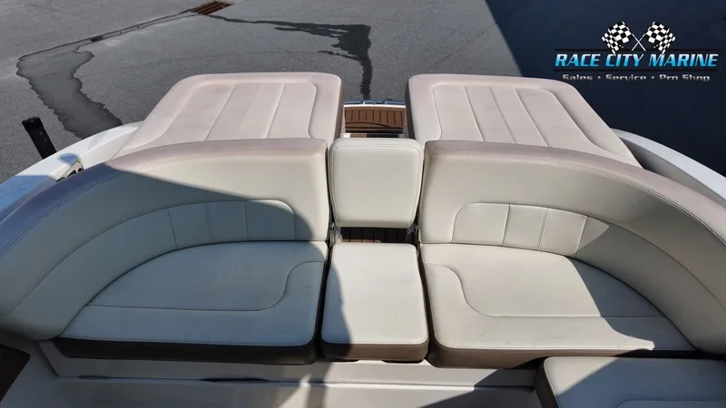 Slide: The Image of The image shows the beige upholstery of a boat's rear seating area, with a small table in the center. - 15
