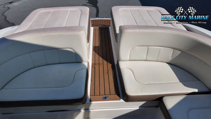Slide: The Image of The image shows the stern of a 2015 Chaparral 277 SSX boat with beige upholstery. - 16