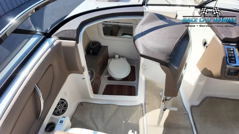 Slide: The Image of The image shows the interior of a 2015 Chaparral 277 SSX with a toilet and seating area. - 26