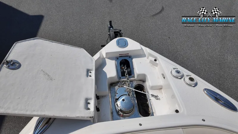 Slide: The Image of The image shows the bow of a Chaparral 277 SSX boat with an anchor compartment. - 38