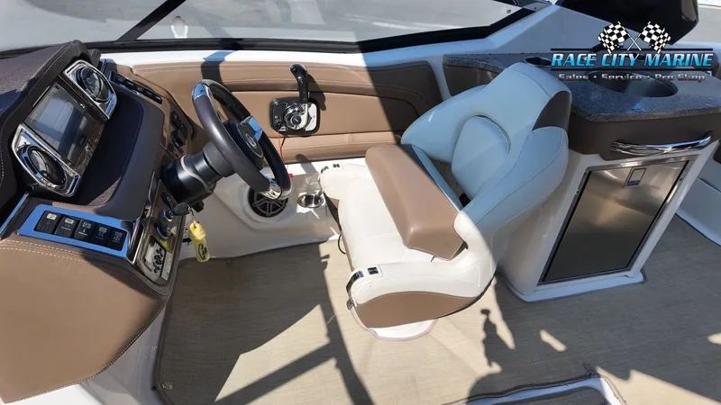Slide: The Image of The image shows the cockpit of a 2015 Chaparral 277 SSX with a beige and white seat. - 33