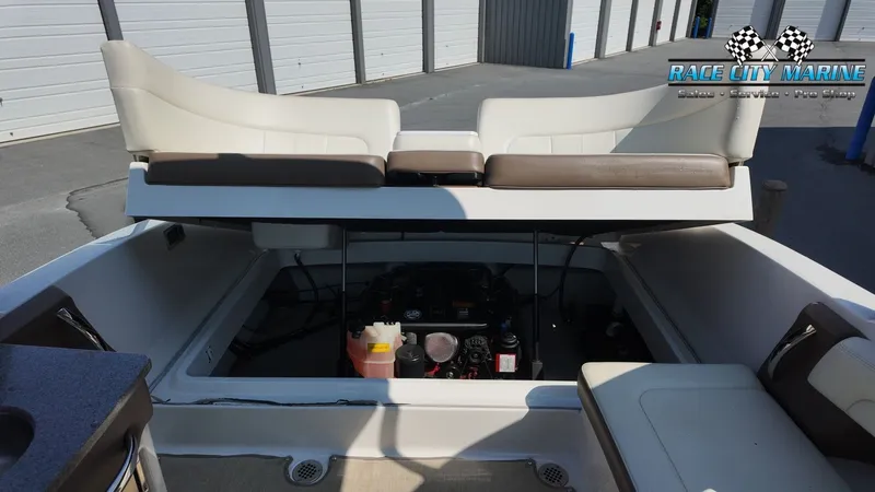 Slide: The Image of The image shows the stern of a 2015 Chaparral 277 SSX with an open engine compartment. - 45