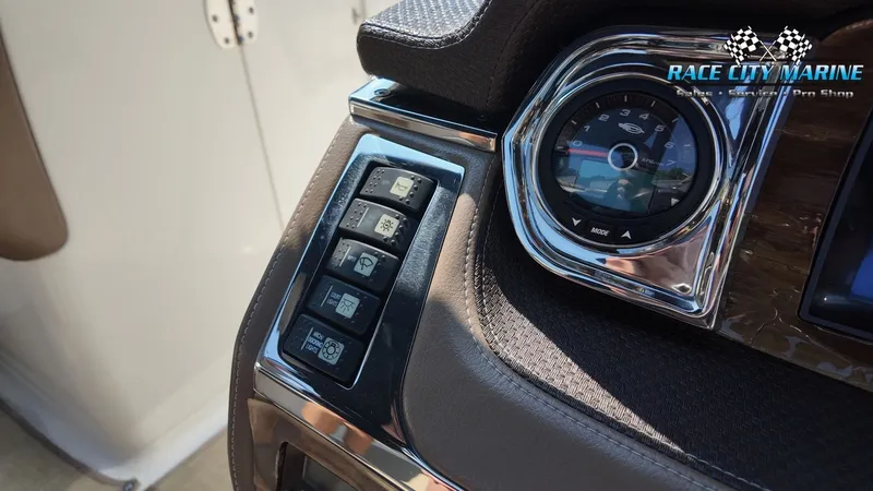 Slide: The Image of Close-up of a 2015 Chaparral 277 SSX dashboard featuring various switches and a speedometer. - 28