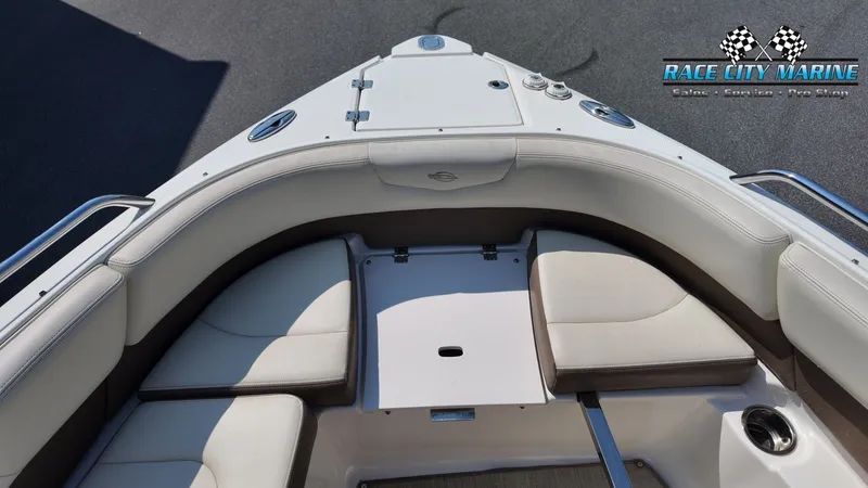Slide: The Image of The image shows the bow seating area of a 2015 Chaparral 277 SSX with white upholstery. - 42