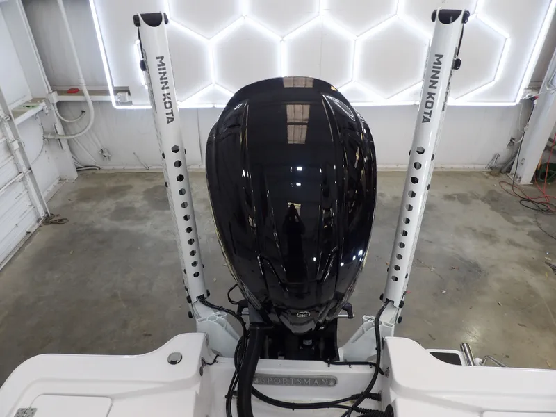 Slide: The Image of A 2022 Sportsman Tournament 214 Bay Boat with a sleek outboard motor and Minn Kota power-pole anchors. - 20