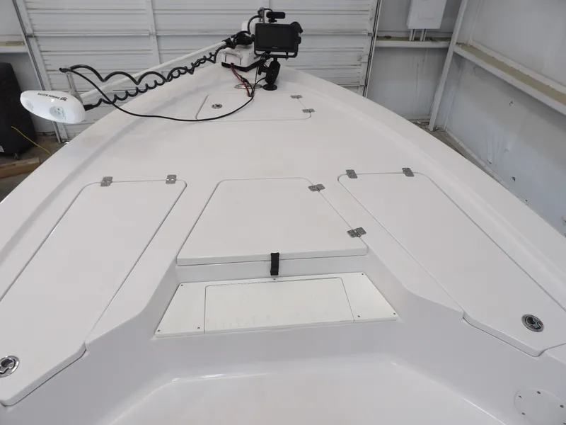 Slide: The Image of The image shows the deck of a 2022 Sportsman Tournament 214 Bay Boat in a storage facility. - 9