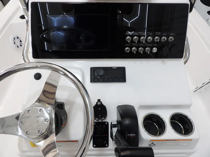 Slide: The Image of The image shows the helm of a 2022 Sportsman Tournament 214 Bay Boat with modern controls. - 16