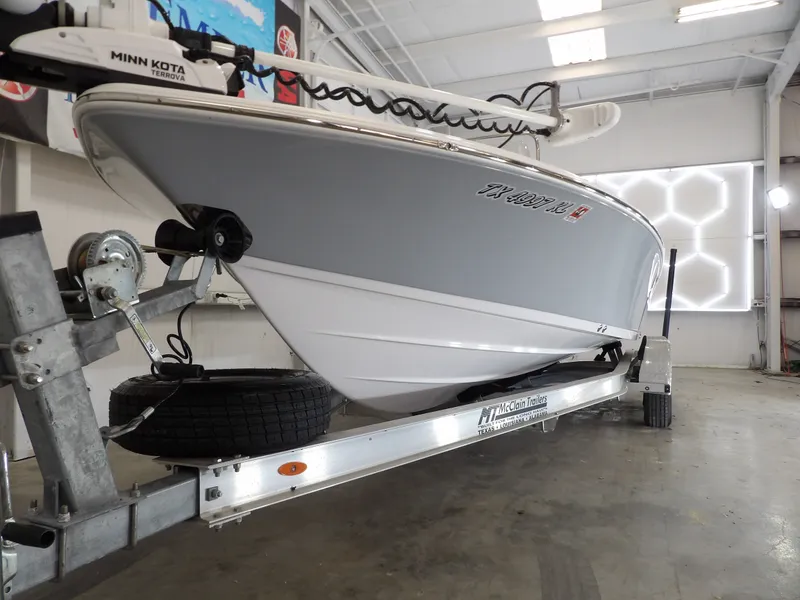 Slide: The Image of A 2022 Sportsman Tournament 214 Bay Boat on a trailer in a warehouse. - 3