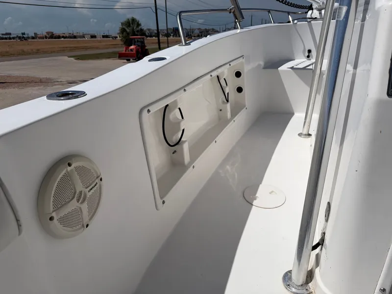 Slide: The Image of The image shows the deck of a 2002 PRO SPORT PRO KAT 2200 boat with a speaker and storage compartment. - 26