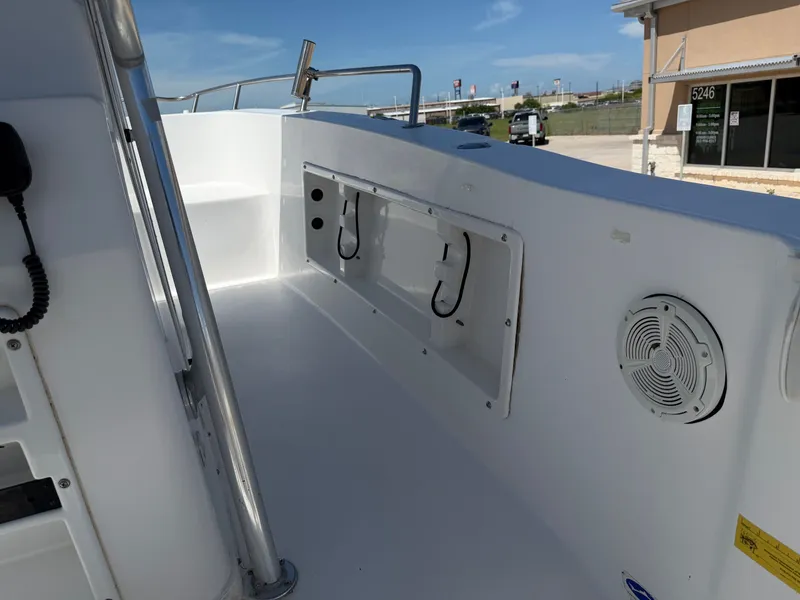 Slide: The Image of The image shows the deck of a 2002 PRO SPORT PRO KAT 2200 boat with storage and a speaker. - 27