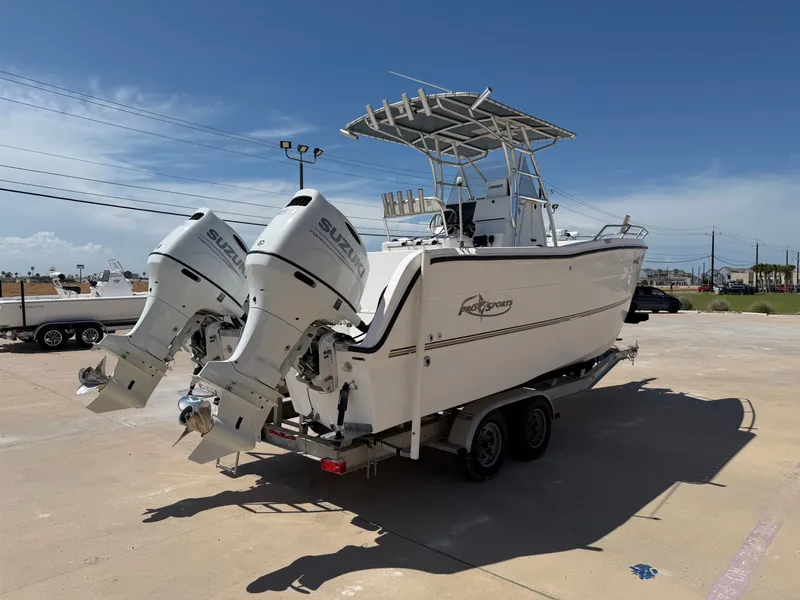 Slide: The Image of A 2002 PRO SPORT PRO KAT 2200 boat with twin outboard engines on a trailer. - 8