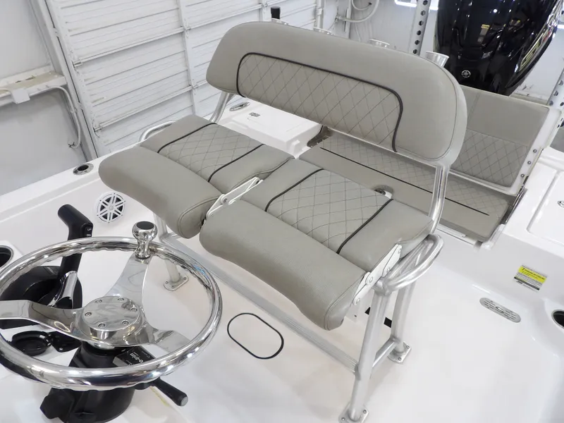 Slide: The Image of The image shows the cockpit of a 2022 Sportsman Tournament 214 Bay Boat with cushioned seating. - 5