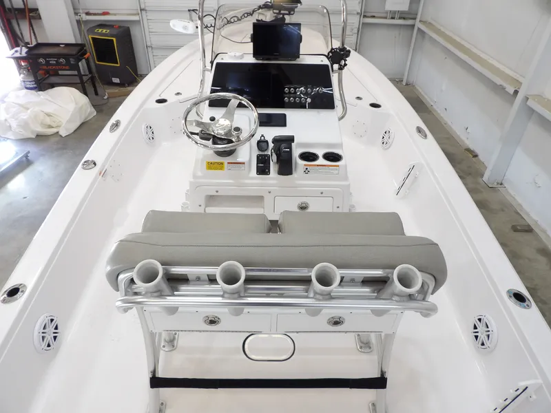 Slide: The Image of The image shows the cockpit of a 2022 Sportsman Tournament 214 Bay Boat with gray seats and helm console. - 19