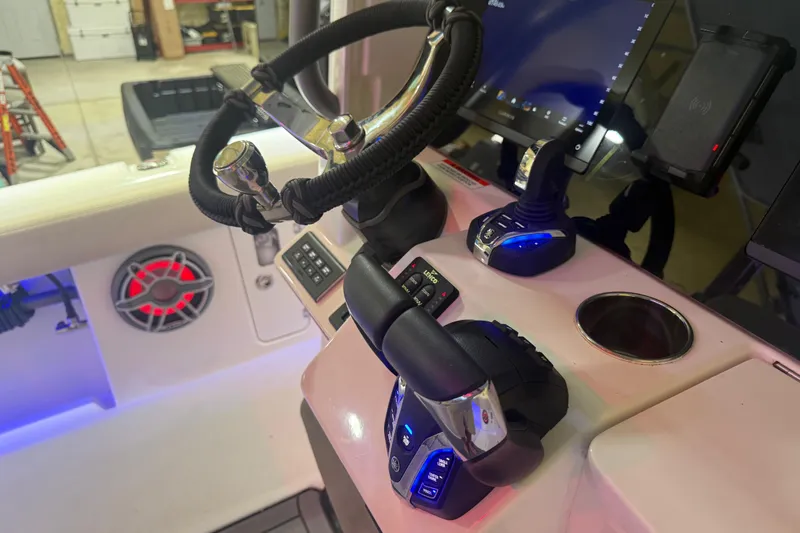 Slide: The Image of Control panel of 2024 Solace 30HCS boat with steering wheel and electronic controls. - 9