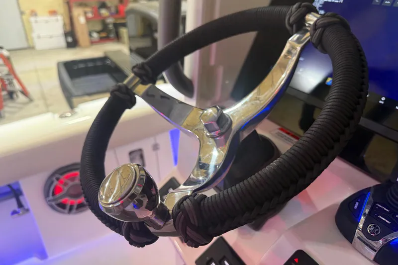 Slide: The Image of Steering wheel of 2024 Solace 30HCS boat, featuring modern design and controls. - 12