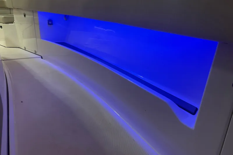 Slide: The Image of 2024 Solace 30HCS boat interior with blue LED lighting. - 28