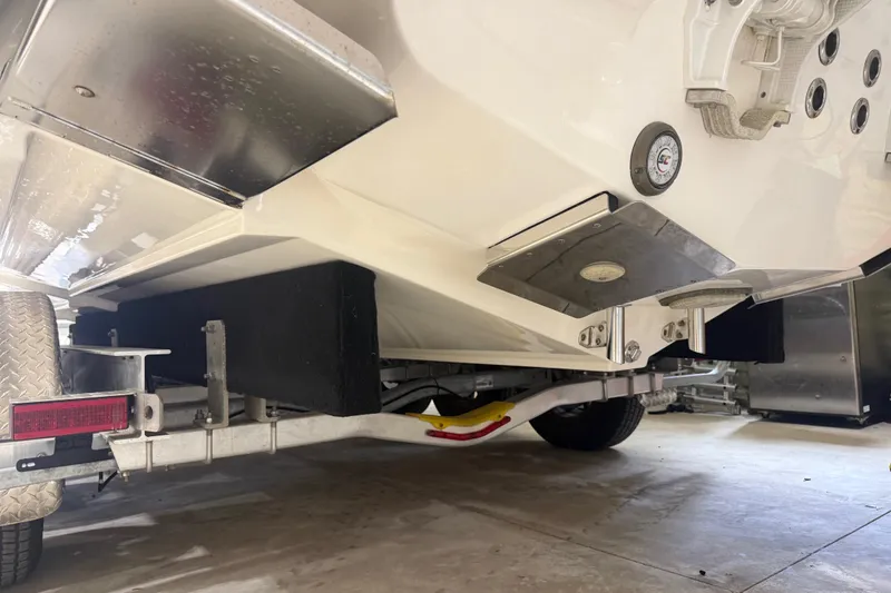 Slide: The Image of 2024 Solace 30HCS boat trailer underside, showcasing hull and trailer details. - 53