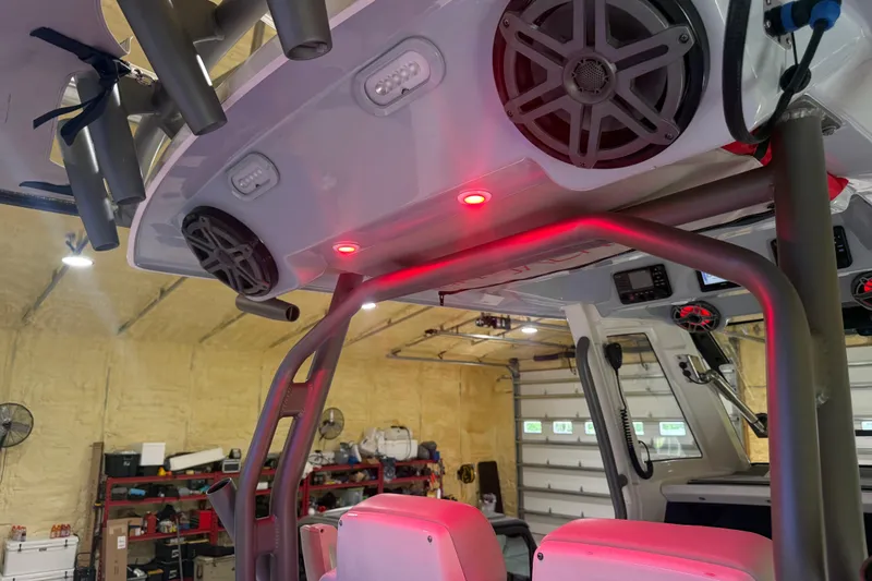 Slide: The Image of 2024 Solace 30HCS boat interior with speakers and red LED lights in a garage. - 27