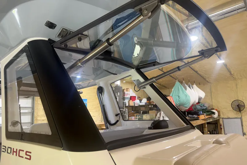 Slide: The Image of 2024 Solace 30HCS boat windshield and cabin interior in a workshop setting. - 39