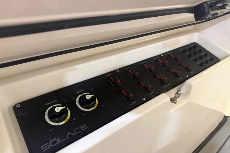 Slide: The Image of Control panel of 2024 Solace 30HCS boat with switches and dials. - 30