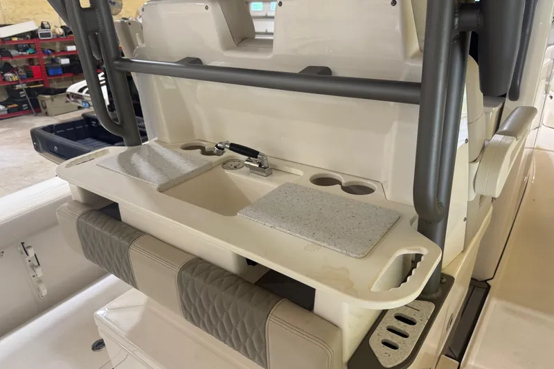 Slide: The Image of 2024 Solace 30HCS boat interior with sink, cutting boards, and cup holders. - 18