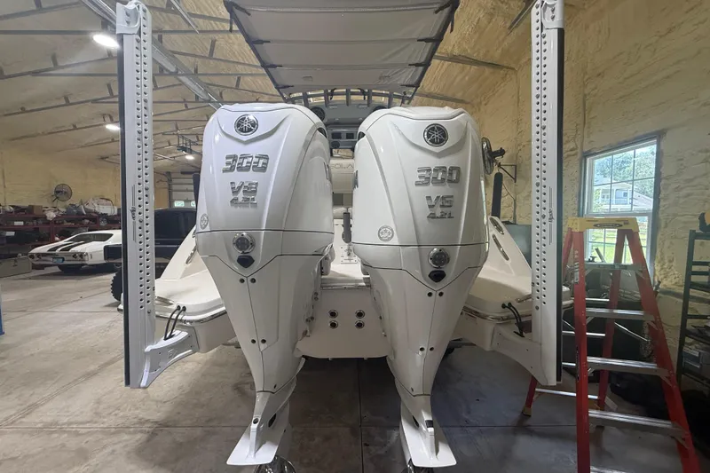 Slide: The Image of 2024 Solace 30HCS boat with twin Yamaha 300 V6 engines in a workshop setting. - 5