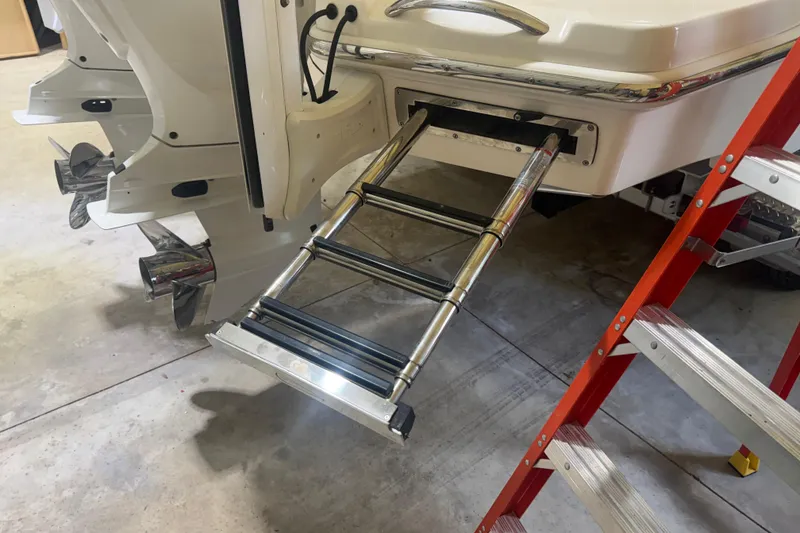 Slide: The Image of 2024 Solace 30HCS boat with extended swim ladder and dual outboard motors. - 45