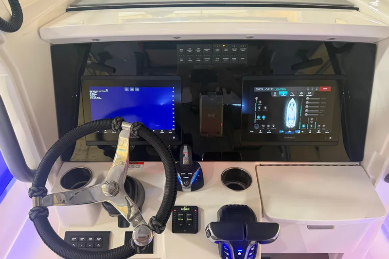 Slide: The Image of 2024 Solace 30HCS boat dashboard with advanced navigation and control screens. - 7